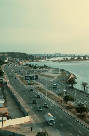 An elevated highway runs beside a body of water.